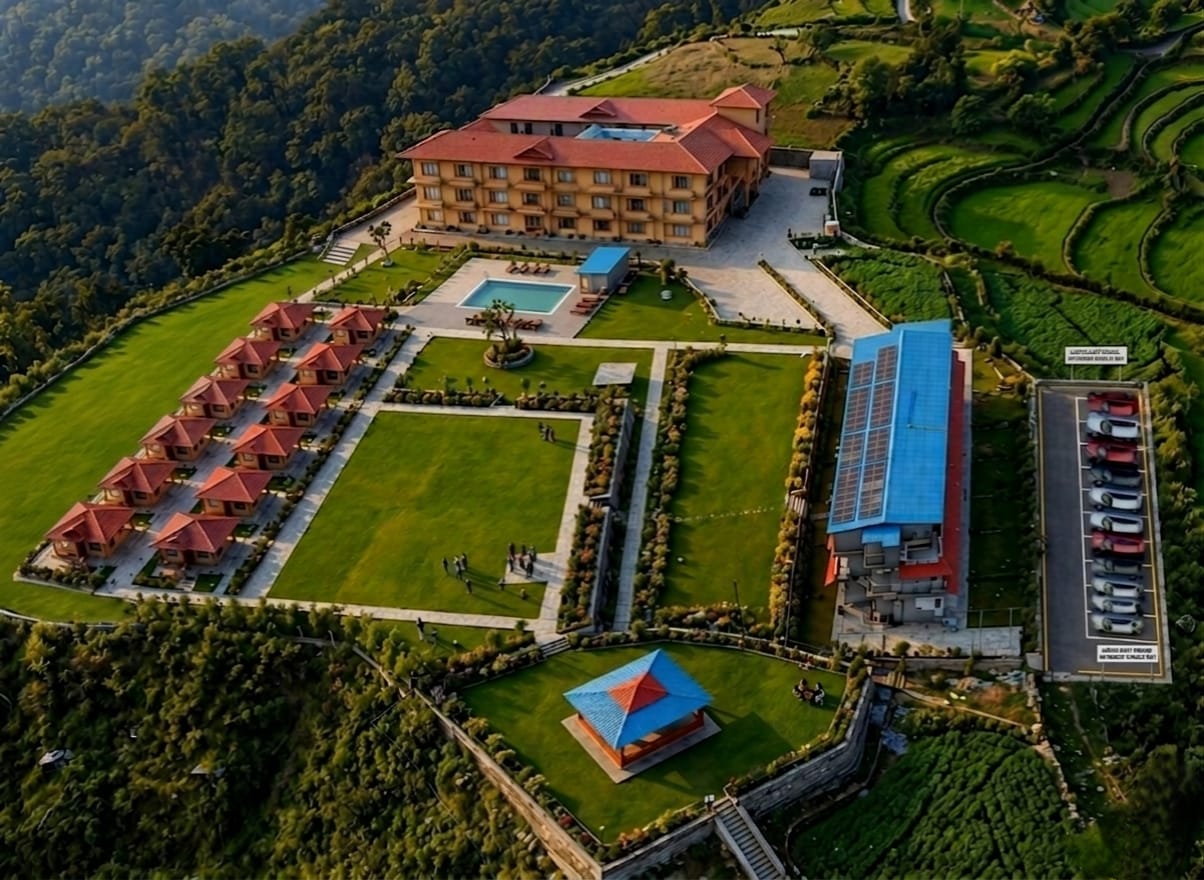 Aerial view of Osho Luxury Resort — hilltop 5-star resort with pool, villas and landscaped gardens