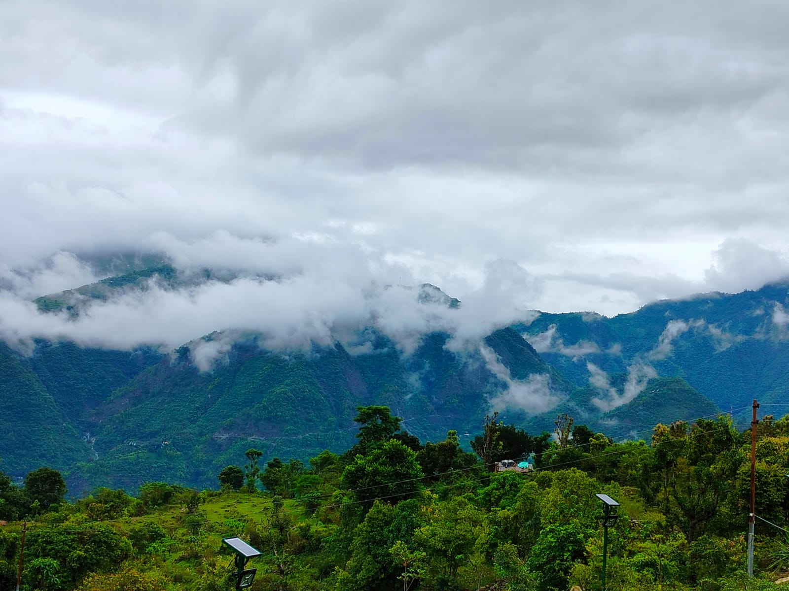 Clouds drifting over lush green Himalayan valleys