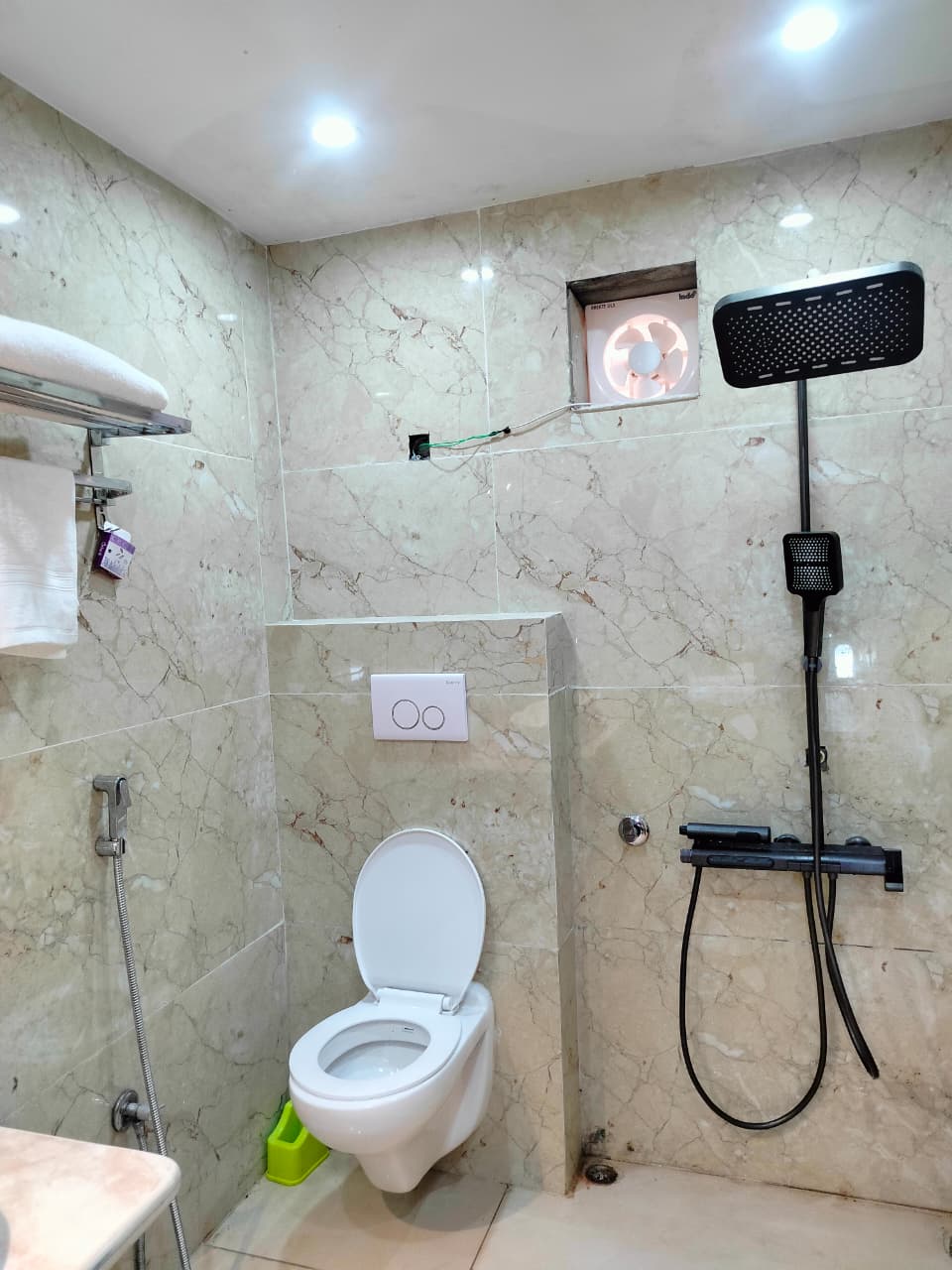 Modern marble bathroom with rain shower and wall-hung fittings