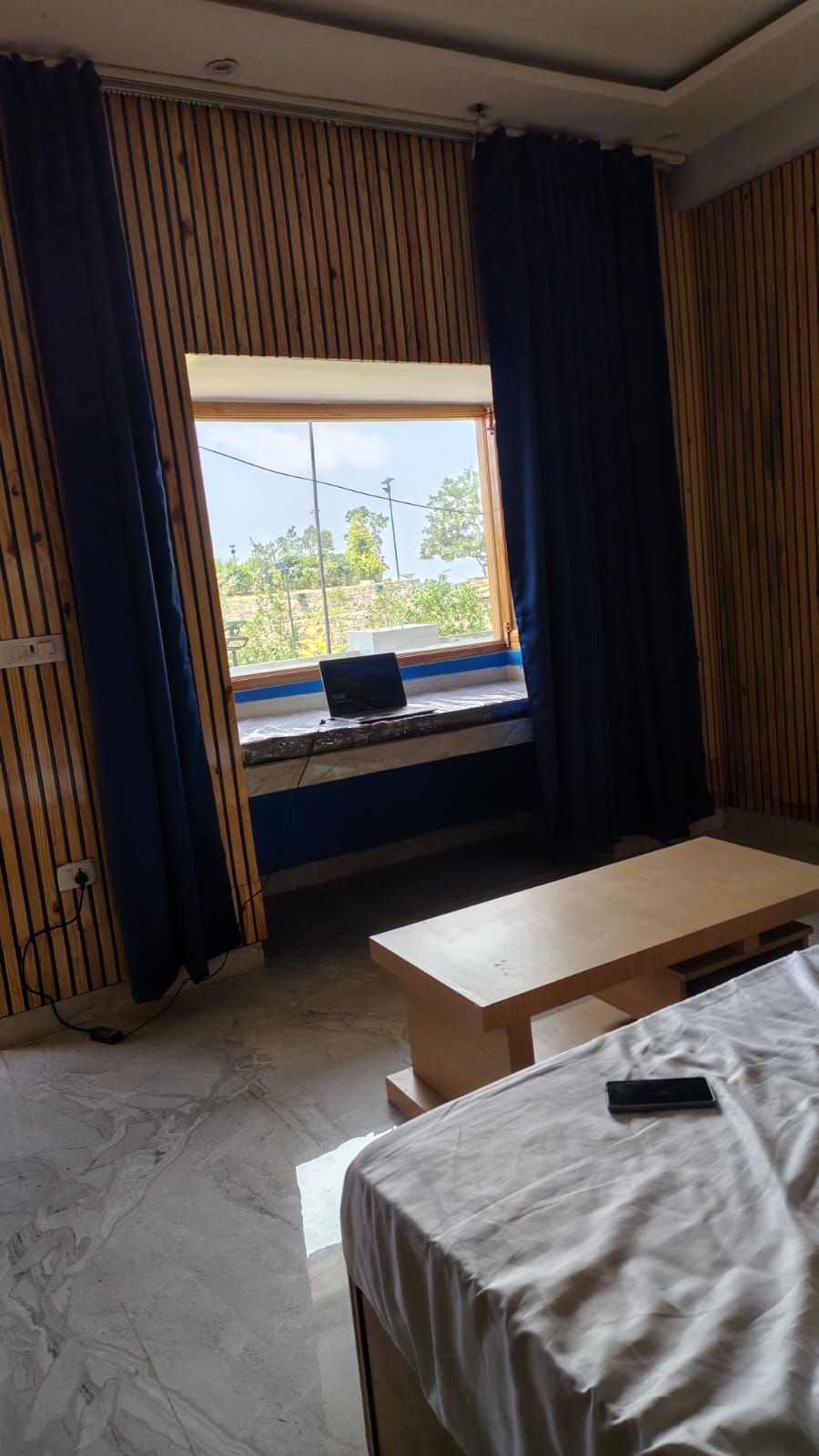 Furnished room with a large picture window opening to the valley